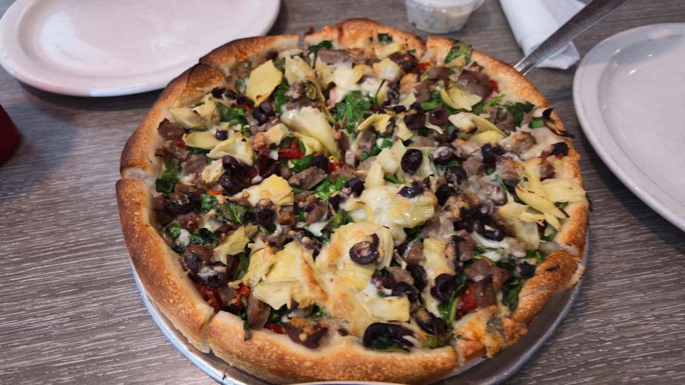 Athens Pizza Santorini pizza with artichokes, Kalamata olives, sun-dried tomatoes, feta and added gyro meat